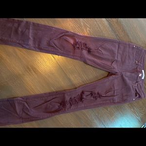 Ripped burgundy jeans